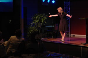 Susan Sparks, stand-up comedian and breast cancer survivor, on stage